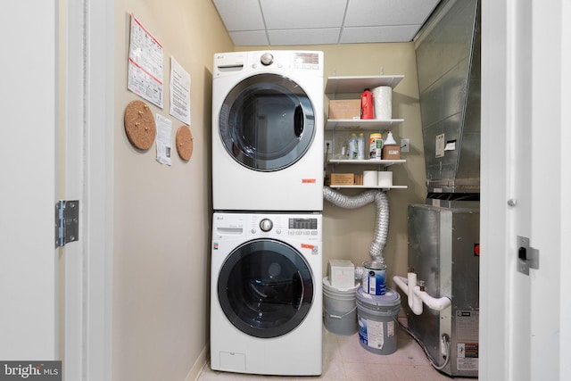 laundry area featuring stacked washer and clothes dryer and laundry area