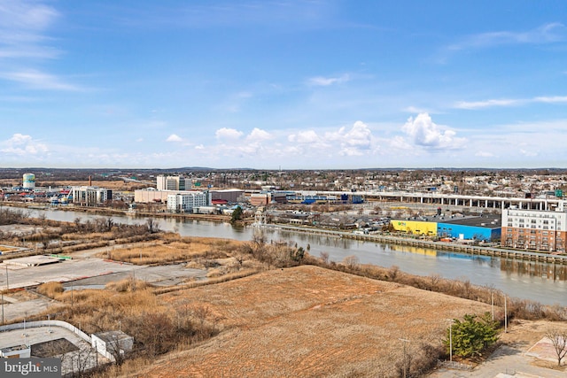 birds eye view of property with a city view and a water view