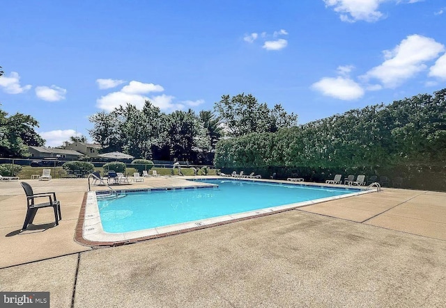 pool with fence and a patio area