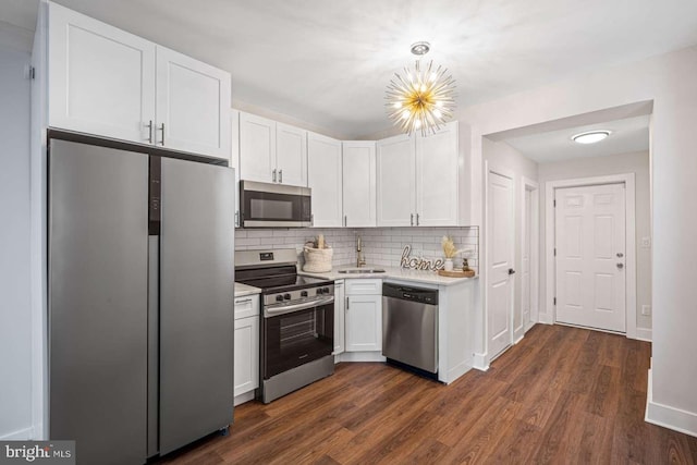 kitchen with a sink, light countertops, white cabinetry, and stainless steel appliances