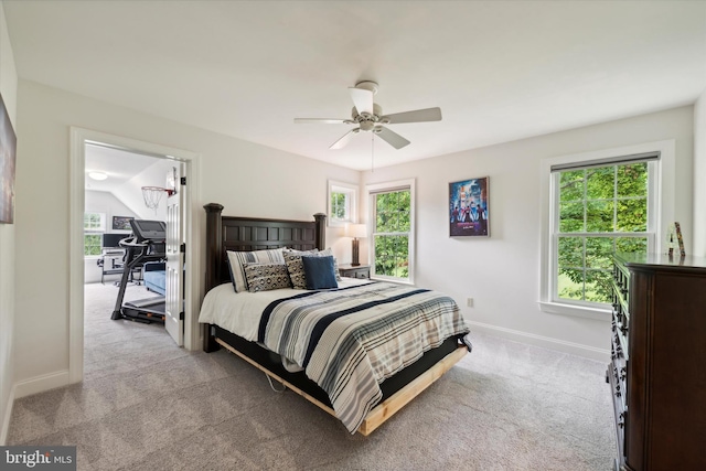 carpeted bedroom with baseboards, multiple windows, and ceiling fan