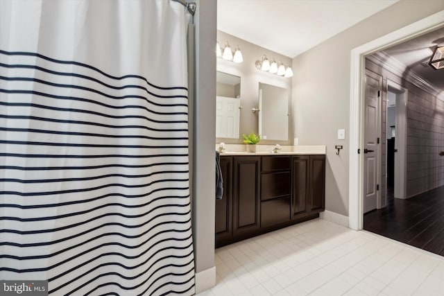 bathroom featuring tile patterned floors, vanity, baseboards, and a shower with curtain