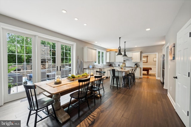 dining area with recessed lighting, baseboards, and dark wood-type flooring