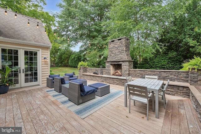 wooden terrace with an outdoor living space with a fireplace