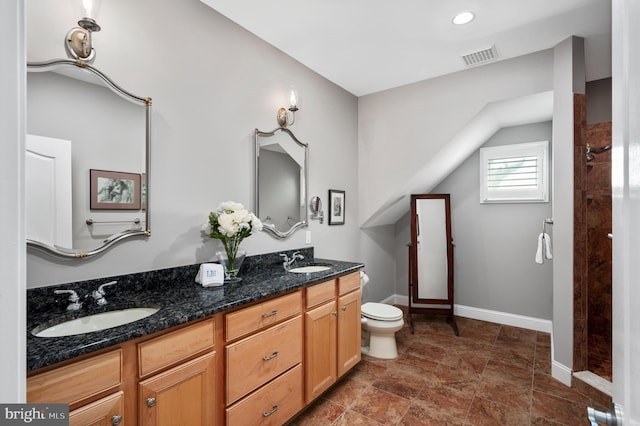 bathroom featuring a sink, visible vents, baseboards, and toilet