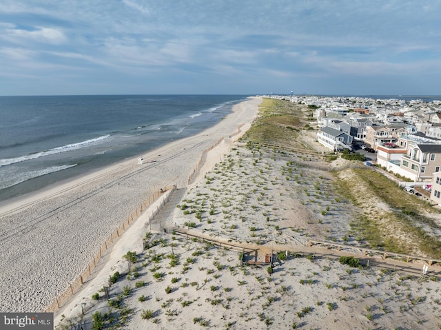 drone / aerial view with a view of the beach and a water view