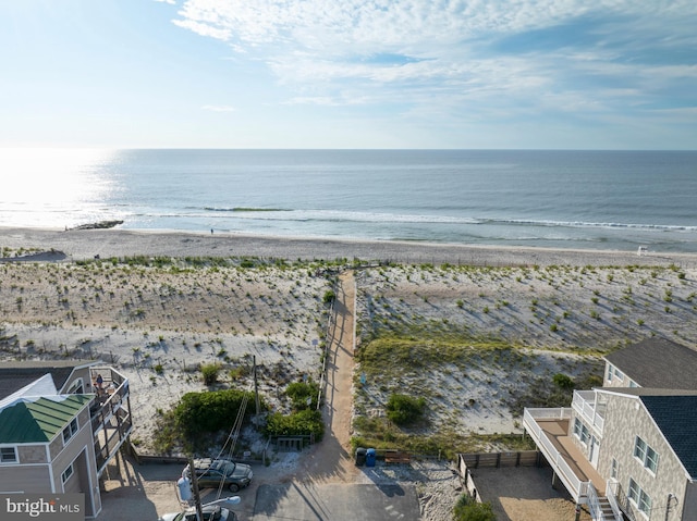 birds eye view of property with a beach view and a water view