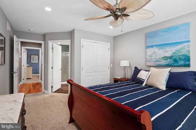 carpeted bedroom with baseboards, recessed lighting, ensuite bathroom, a closet, and a ceiling fan