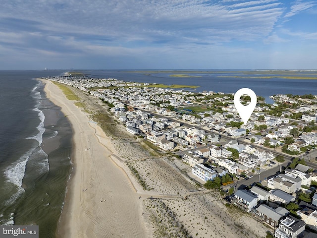 birds eye view of property with a view of the beach and a water view