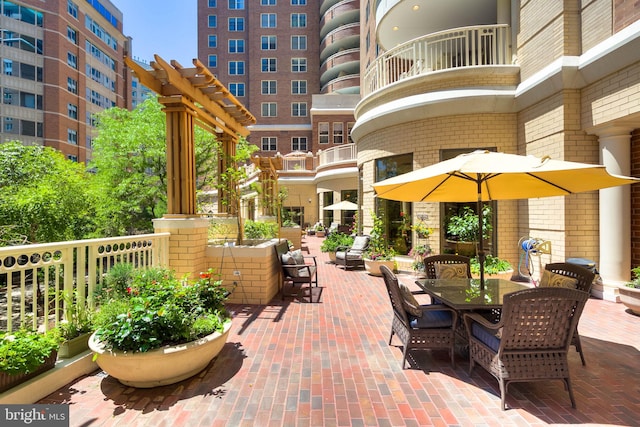 view of property's community with a patio and outdoor dining space