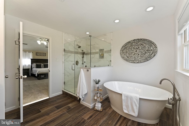 bathroom featuring recessed lighting, ensuite bath, a shower stall, a freestanding tub, and wood tiled floor