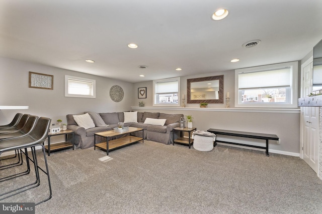 carpeted living area with visible vents, a healthy amount of sunlight, and recessed lighting