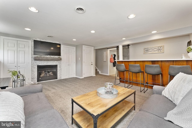 living room featuring recessed lighting, stairway, carpet, visible vents, and a bar