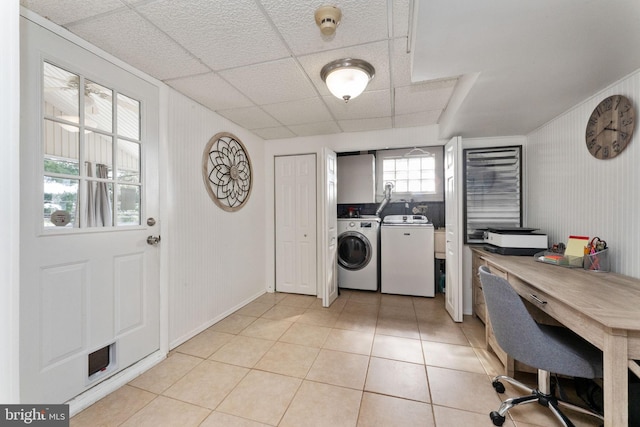 laundry room featuring light tile patterned floors, washer and clothes dryer, and laundry area