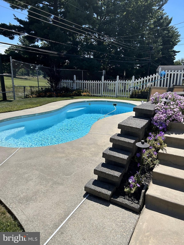 view of swimming pool featuring fence and a fenced in pool