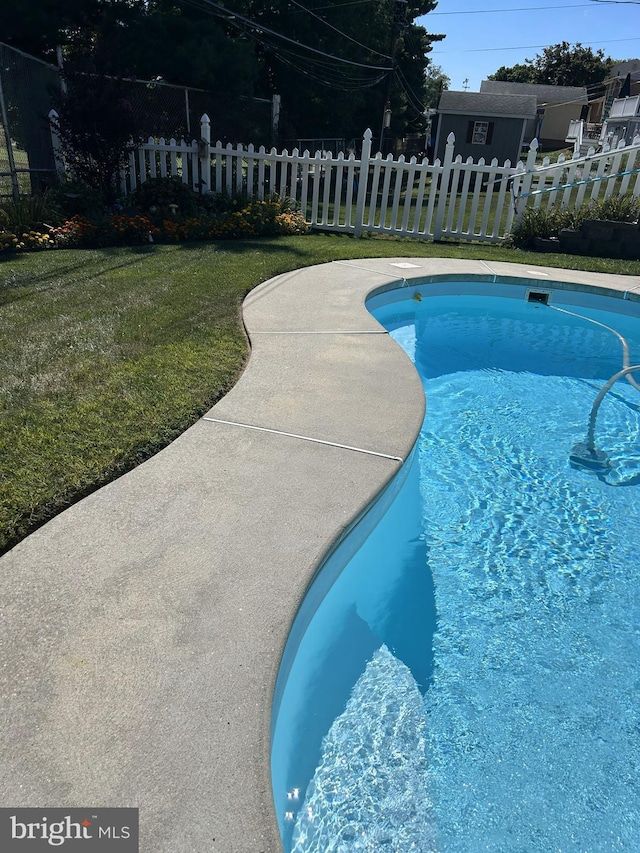 view of pool with a lawn, a fenced in pool, and fence
