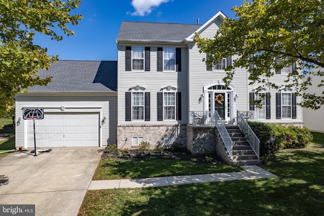 view of front of house featuring a garage, concrete driveway, a front yard, and a shingled roof