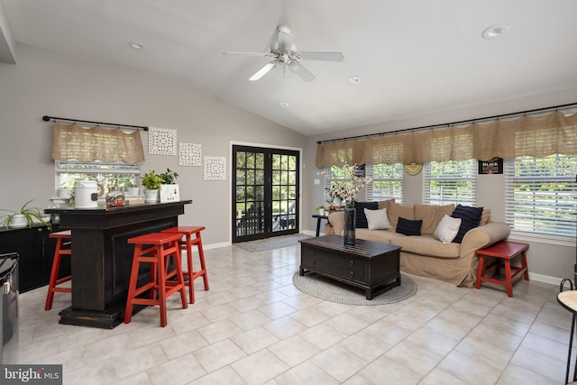living room featuring tile patterned floors, a ceiling fan, recessed lighting, baseboards, and vaulted ceiling
