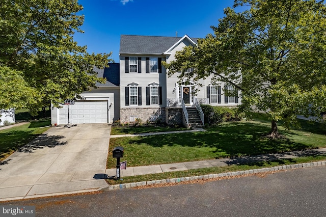 colonial home with a front lawn, stone siding, roof with shingles, concrete driveway, and a garage