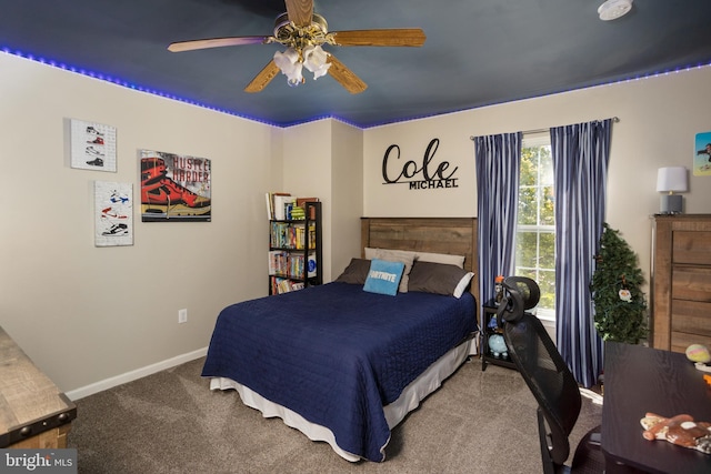 carpeted bedroom with a ceiling fan and baseboards