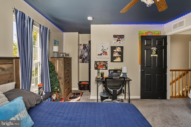 carpeted bedroom featuring visible vents, baseboards, and a ceiling fan