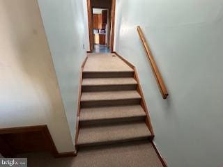 stairway featuring baseboards