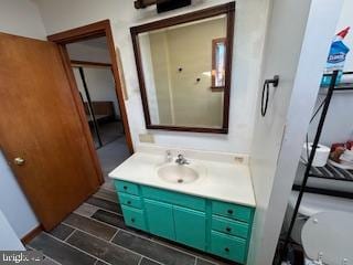 bathroom featuring toilet and vanity