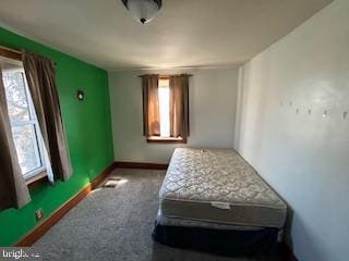 carpeted bedroom featuring baseboards