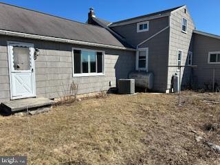 rear view of property featuring cooling unit