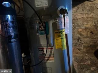 utility room featuring water heater