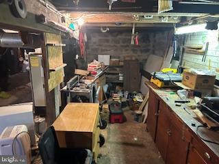 unfinished basement featuring a workshop area