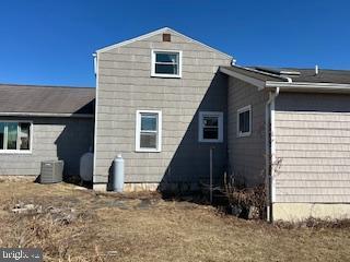 rear view of property featuring central AC