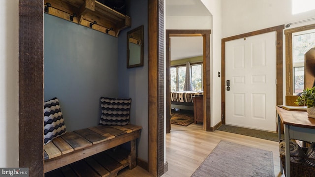 foyer entrance with wood finished floors and baseboards