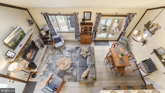 living area with wood finished floors and a lit fireplace