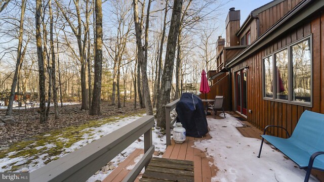 wooden deck featuring outdoor dining space and area for grilling