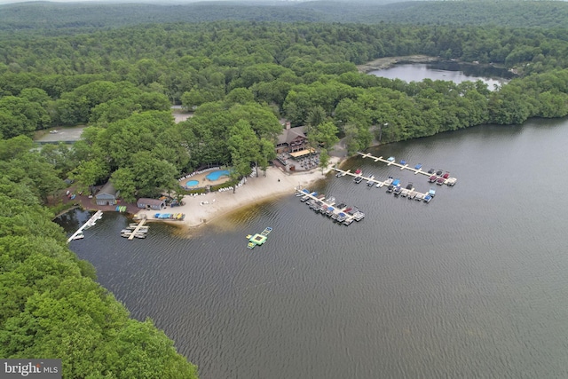 drone / aerial view featuring a view of trees and a water view