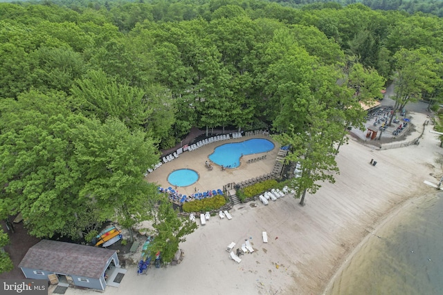 birds eye view of property with a wooded view