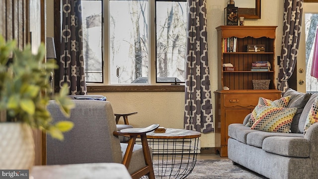 sitting room featuring wood finished floors and a textured wall