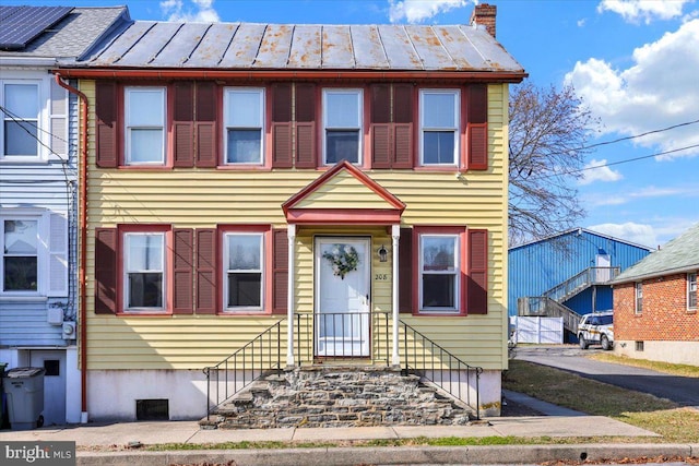 multi unit property with a standing seam roof and a chimney