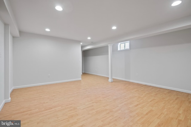 basement with recessed lighting, light wood-type flooring, and baseboards