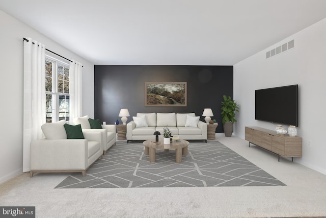 carpeted living room featuring visible vents and baseboards