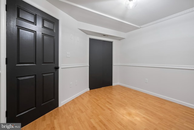 unfurnished room featuring light wood finished floors and baseboards