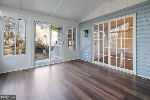 unfurnished sunroom featuring vaulted ceiling