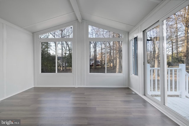 unfurnished sunroom featuring vaulted ceiling with beams