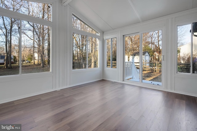 unfurnished sunroom featuring vaulted ceiling