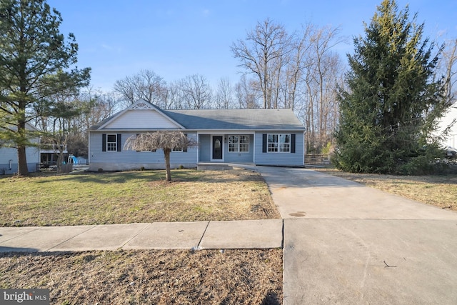 ranch-style house with driveway and a front yard