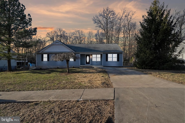 ranch-style home featuring a front yard and driveway