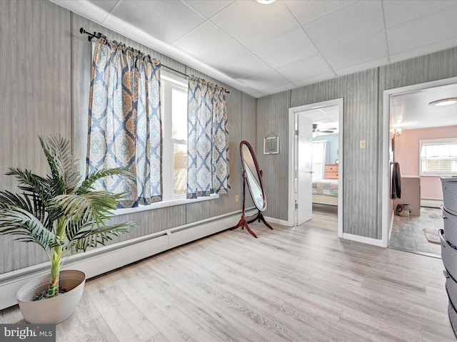 interior space with wood finished floors, baseboards, and a baseboard radiator