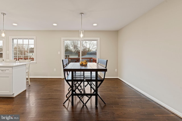 dining space with dark wood-type flooring, recessed lighting, and baseboards