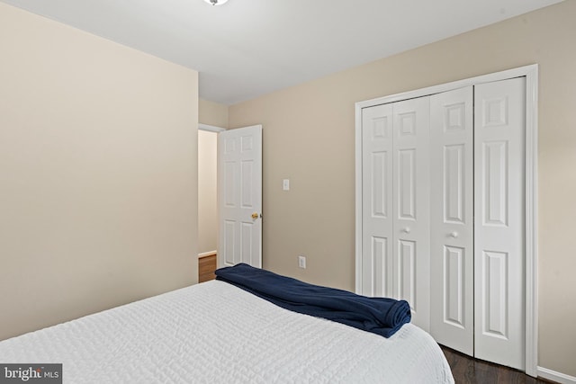 bedroom featuring dark wood-style floors and a closet